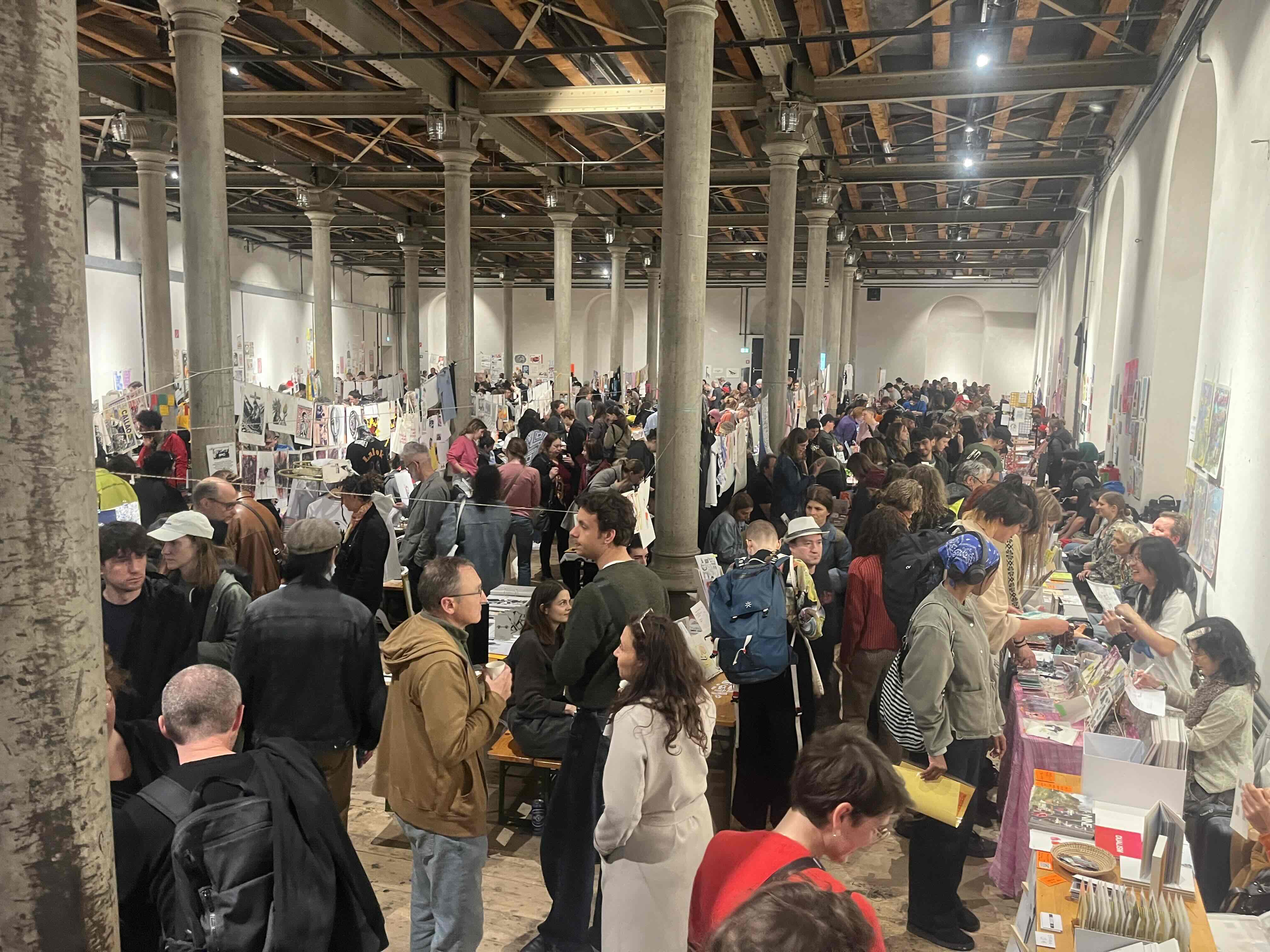 Visitors and exhibitors filling the space at Fanzineist Vienna 2025